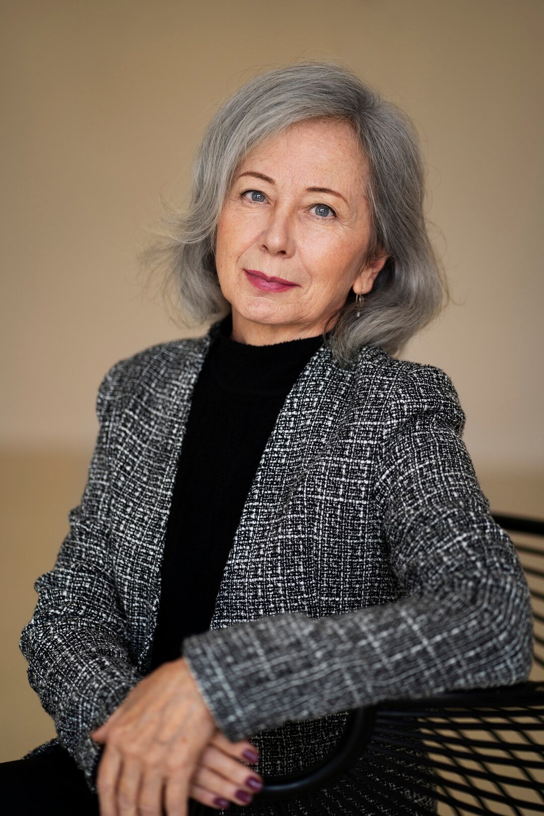 medium-shot-wise-woman-posing-studio_23-2149883504