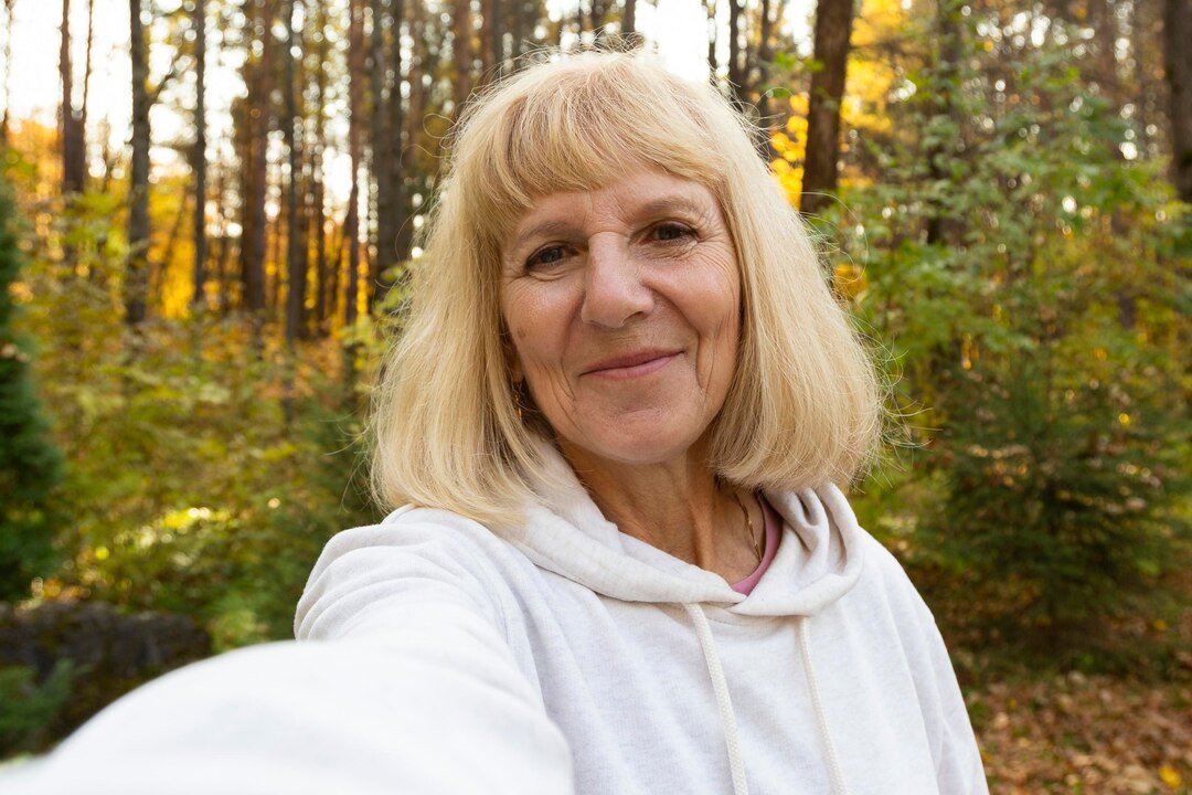 older-woman-taking-selfie-outdoors-nature_23-2148740703