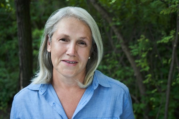 portrait-beautiful-gray-haired-elderly-woman-smiling-park-background_154092-451